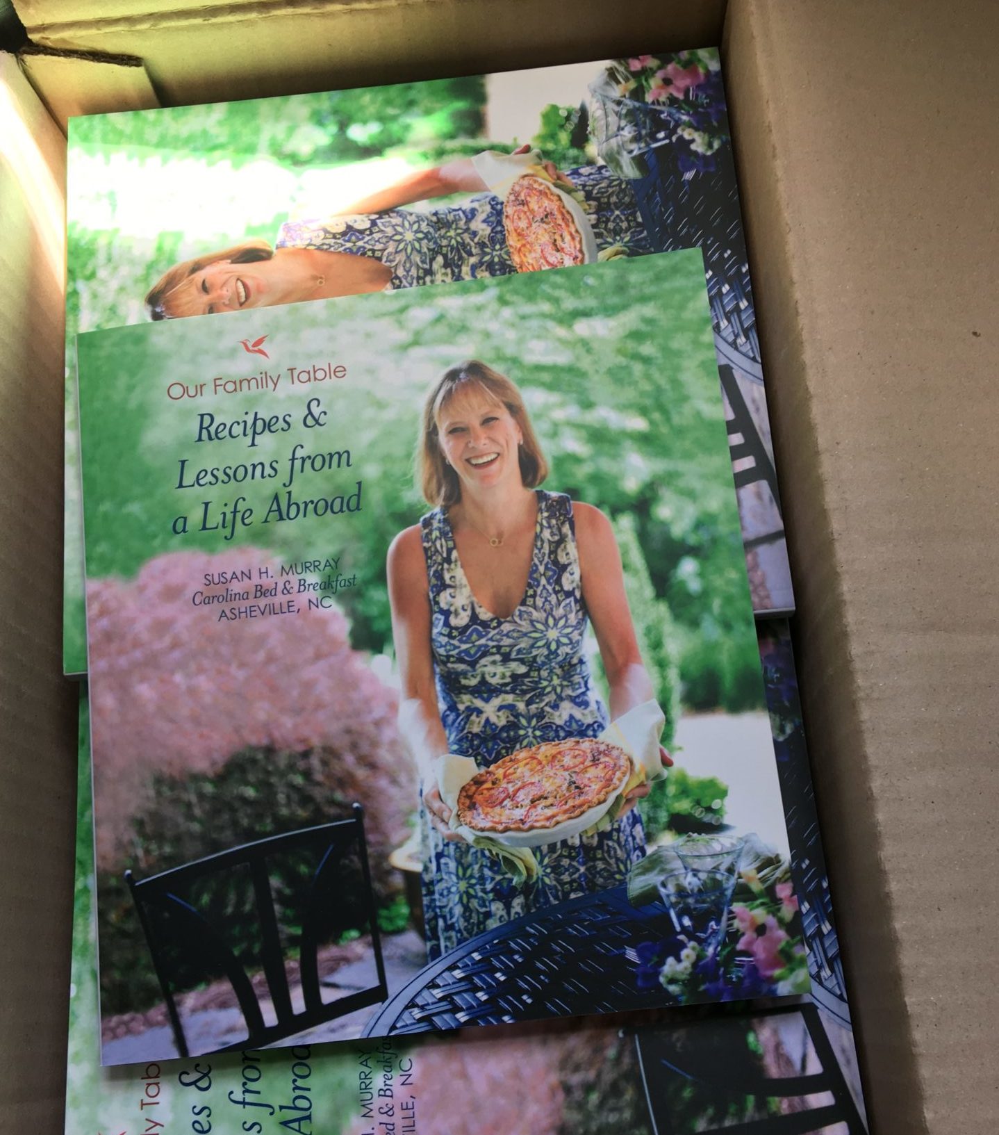 Cookbook with woman and quiche in garden