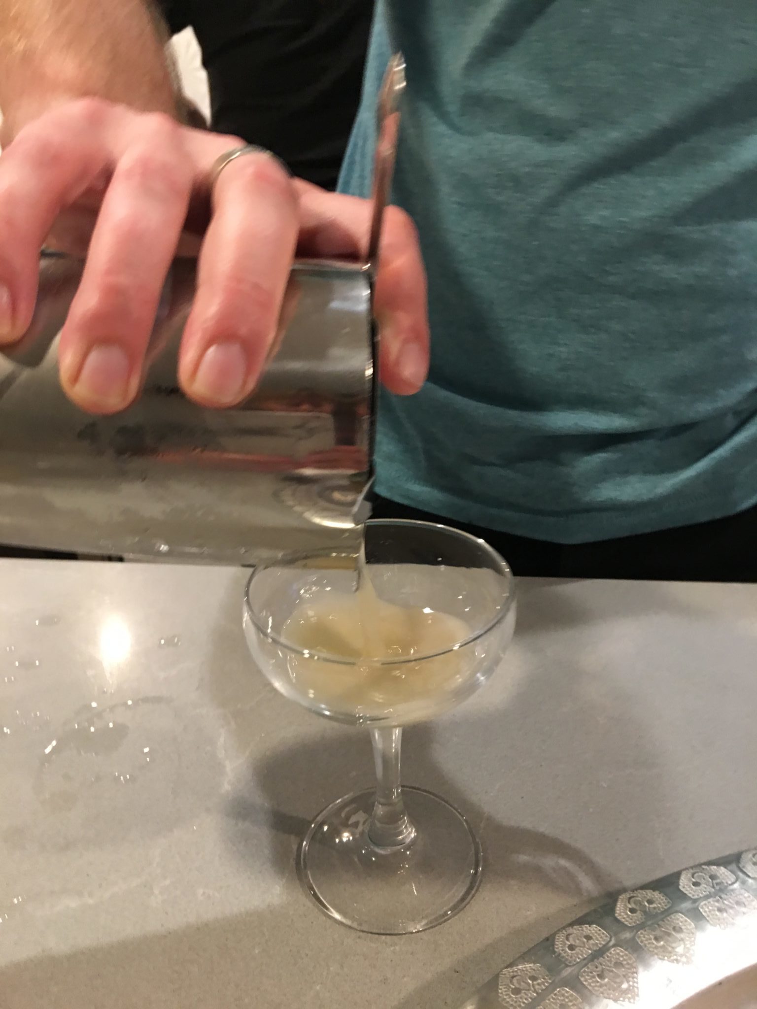 Pouring a cocktail into a glass