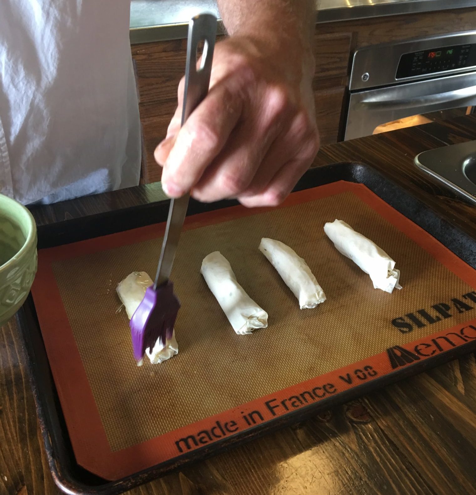 Brush filo rolls with butter before cooking