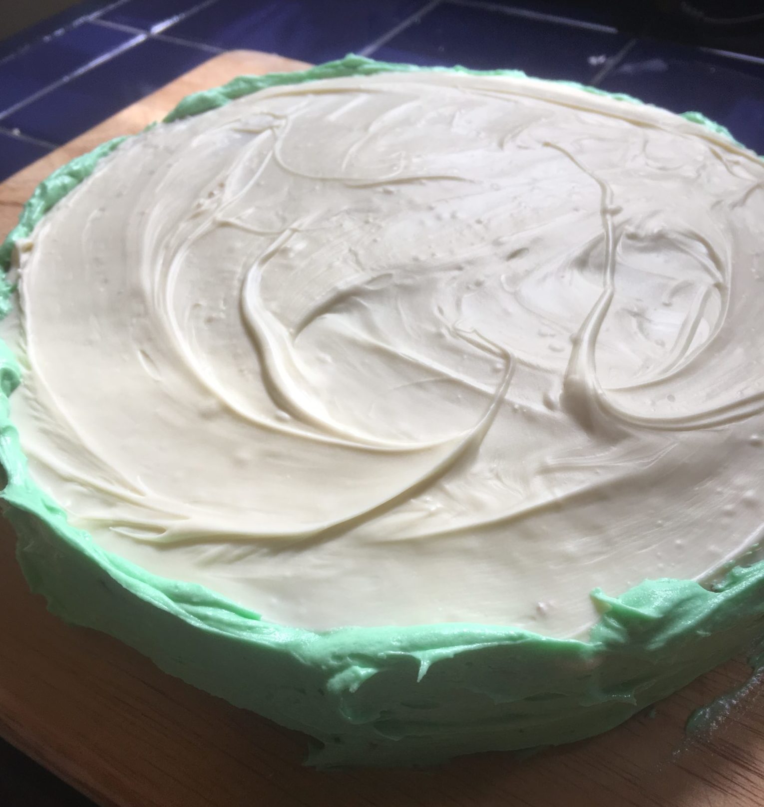 Green icing and white chocolate form the rind of the watermelon cake