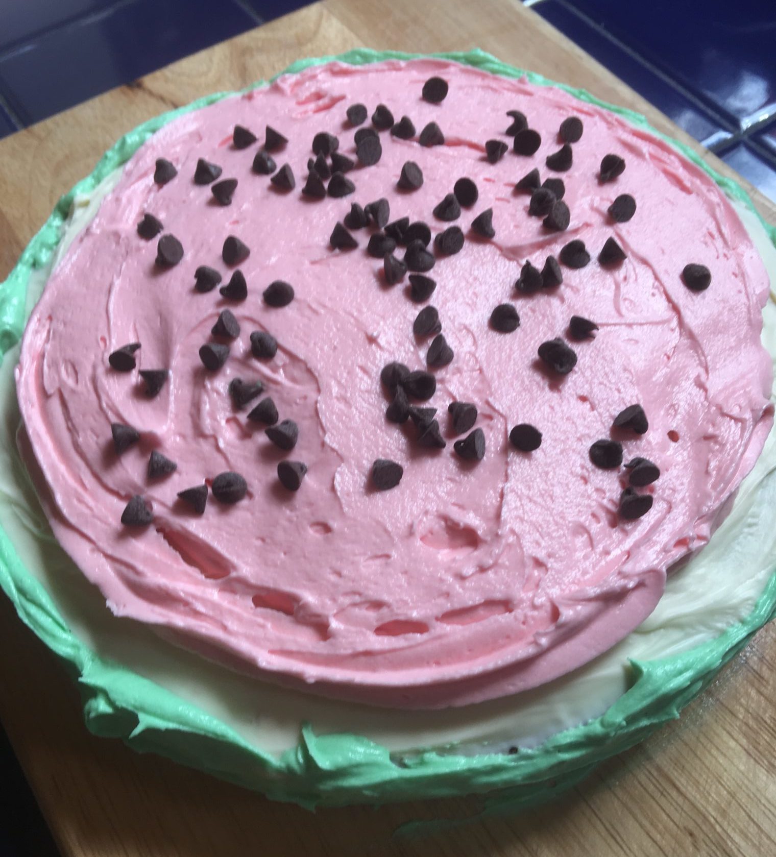 Single layer cake shaped like a watermelon slice