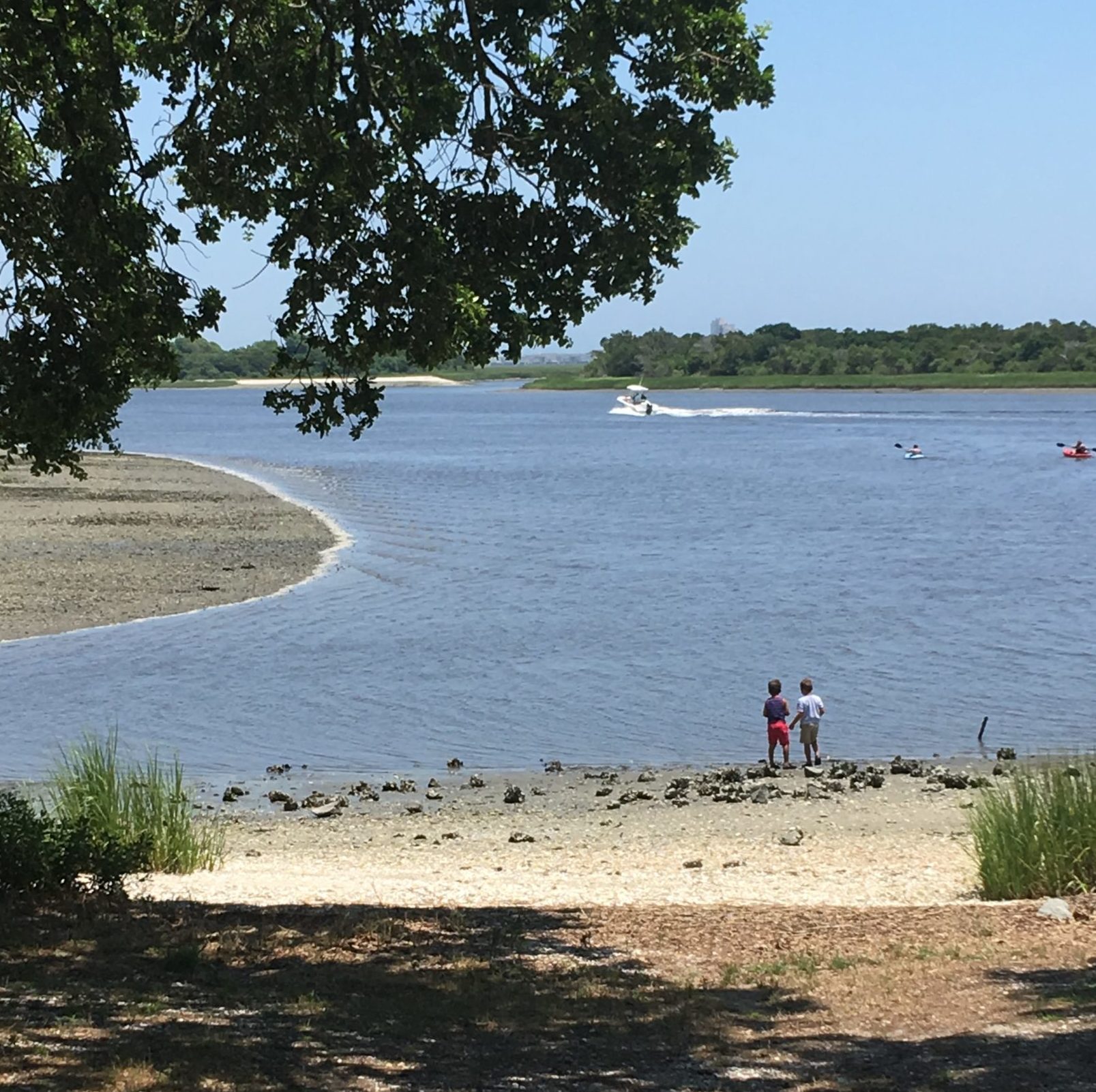 Children playing the sand by the intercoastal waterway