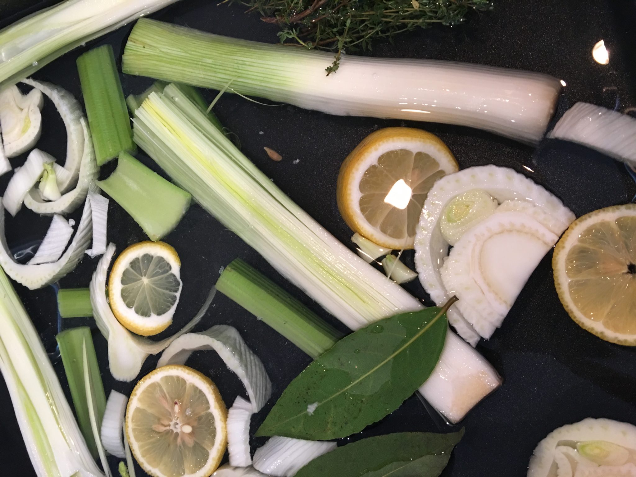leeks, lemons, fennel and celery in poacher