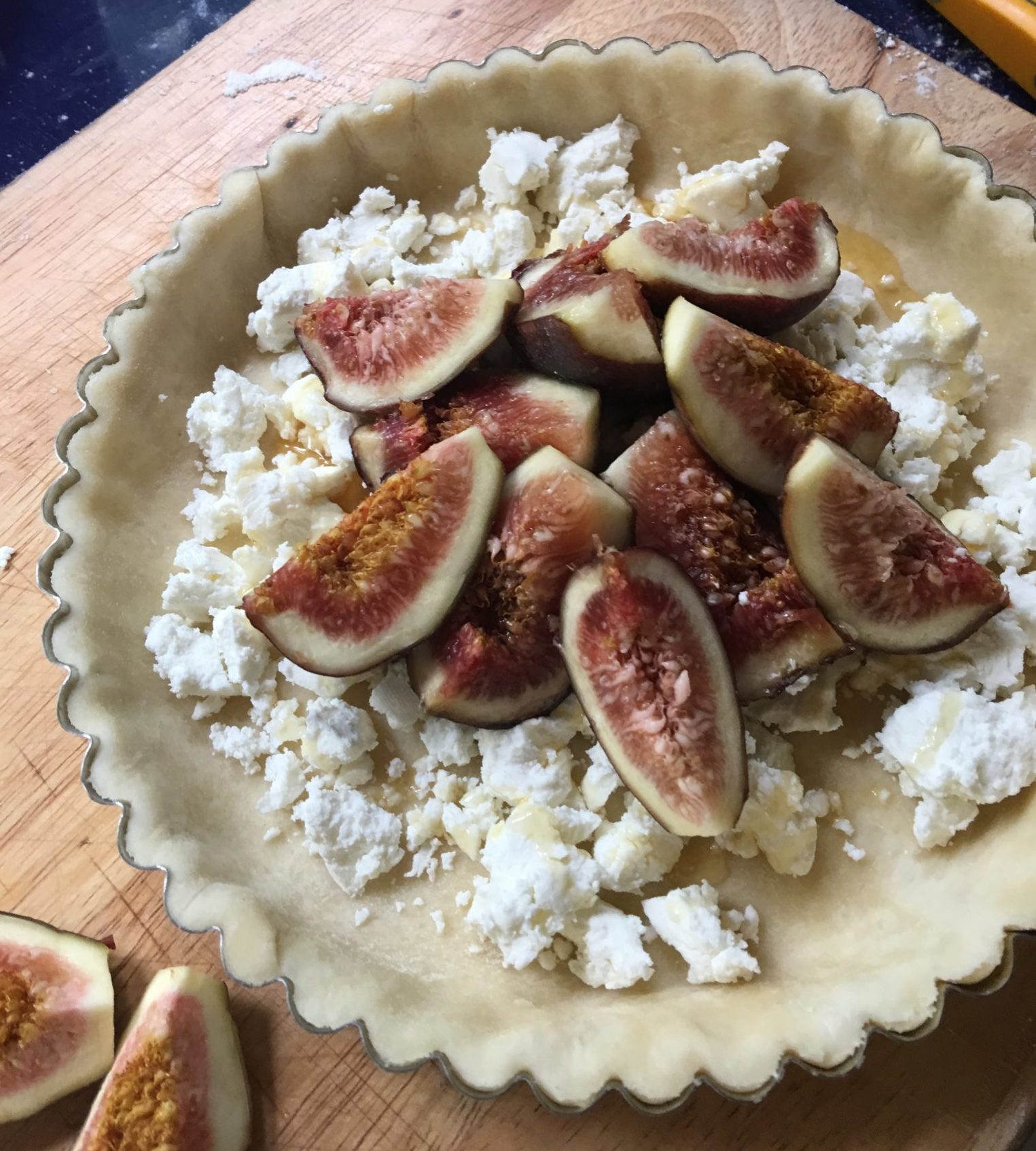 Fresh figs in tart tin over goat cheese