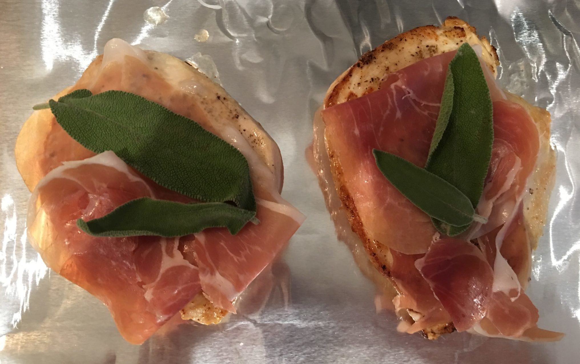 Prosciutto and sage leaves on chicken breasts