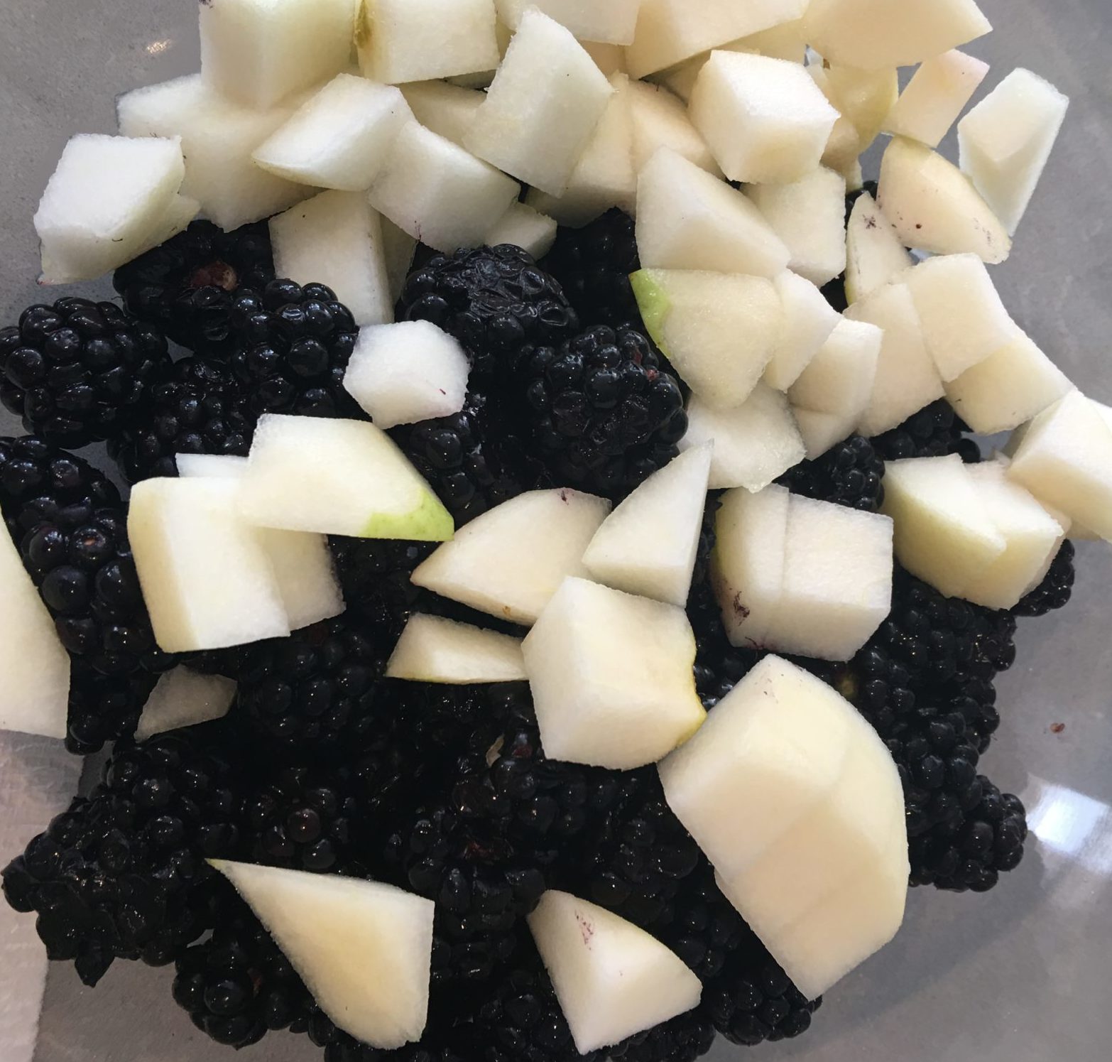 Fresh blackberries with pears cut to similar size