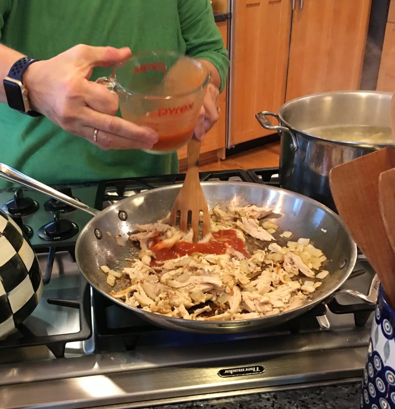 chicken and hot sauce in a frying pan