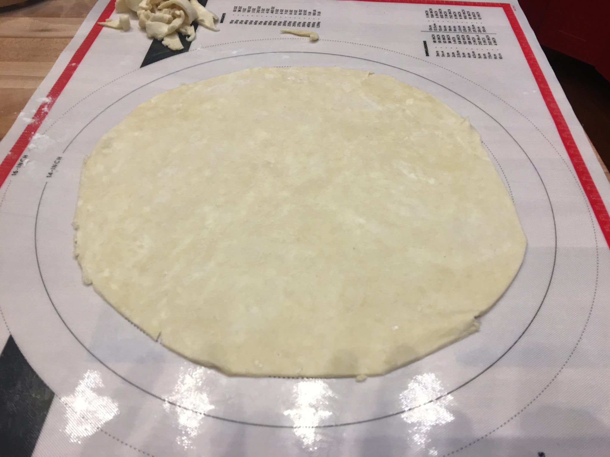 Single crust pie pastry rolled on mat