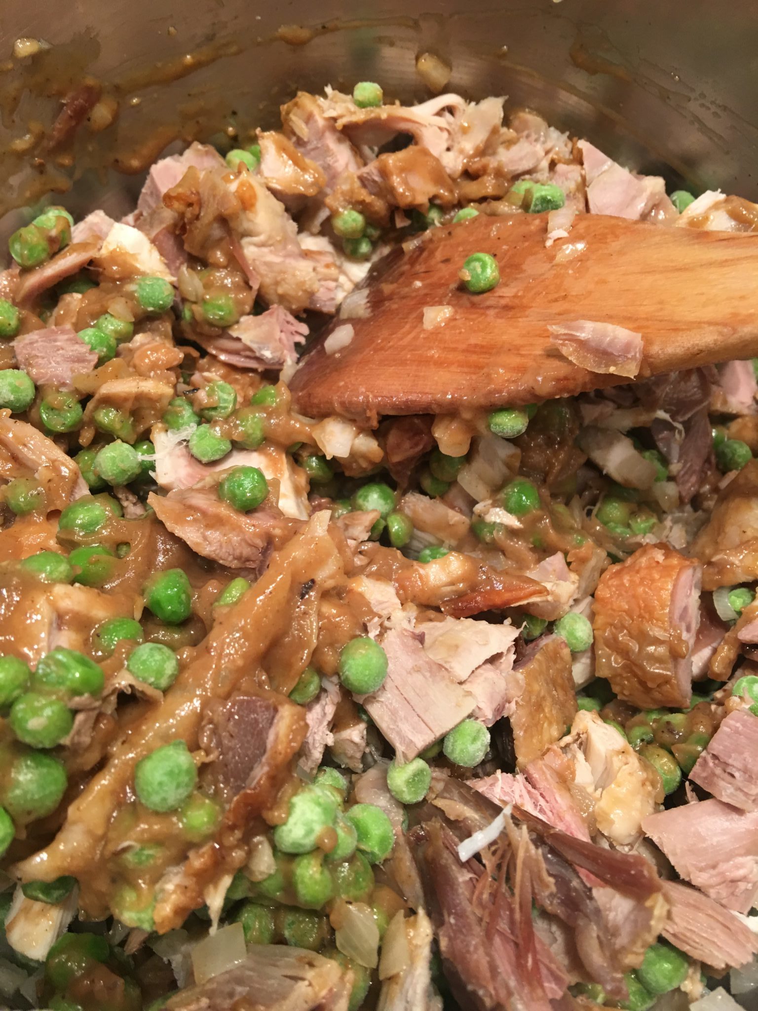 Peas, turkey meat and gravy in a pot