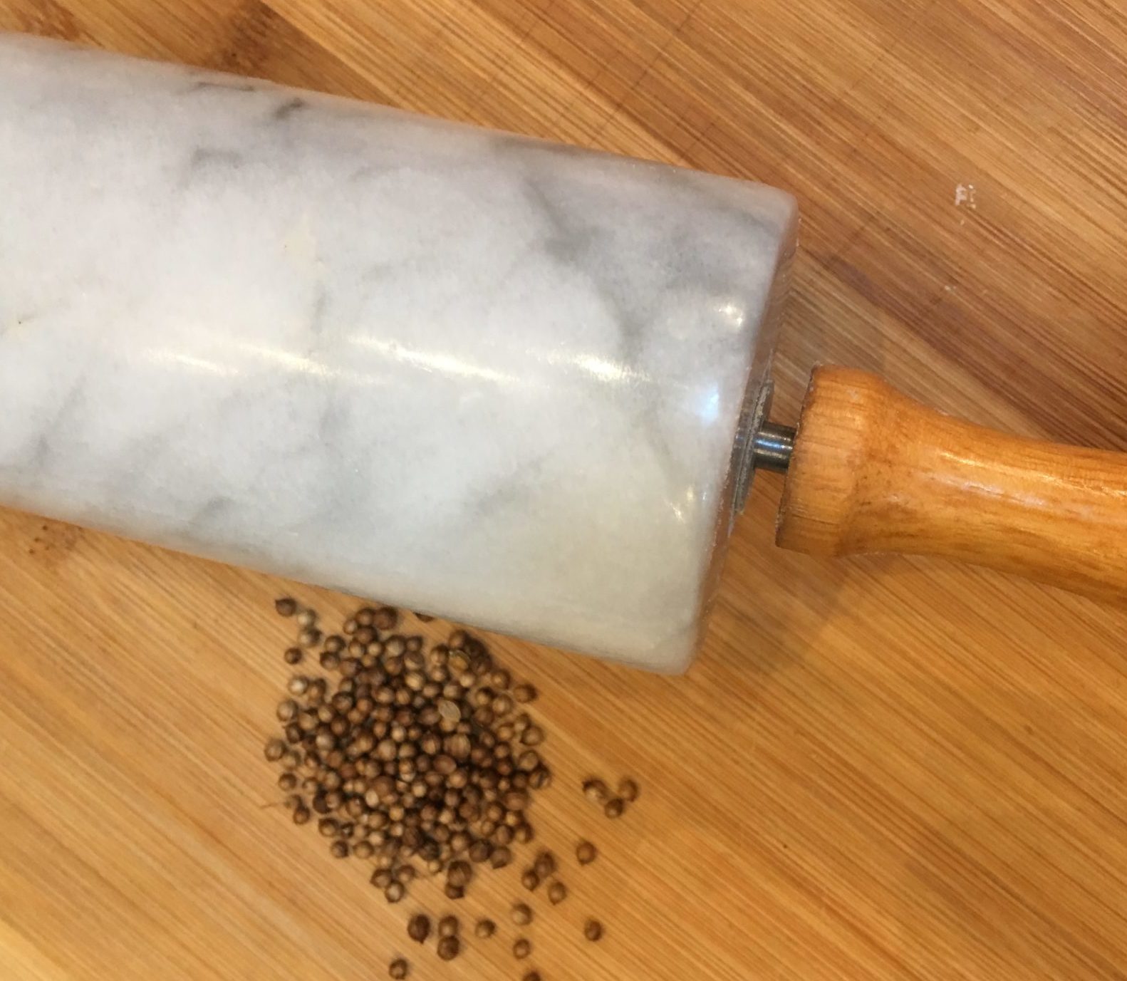 Coriander seed and a rolling pin