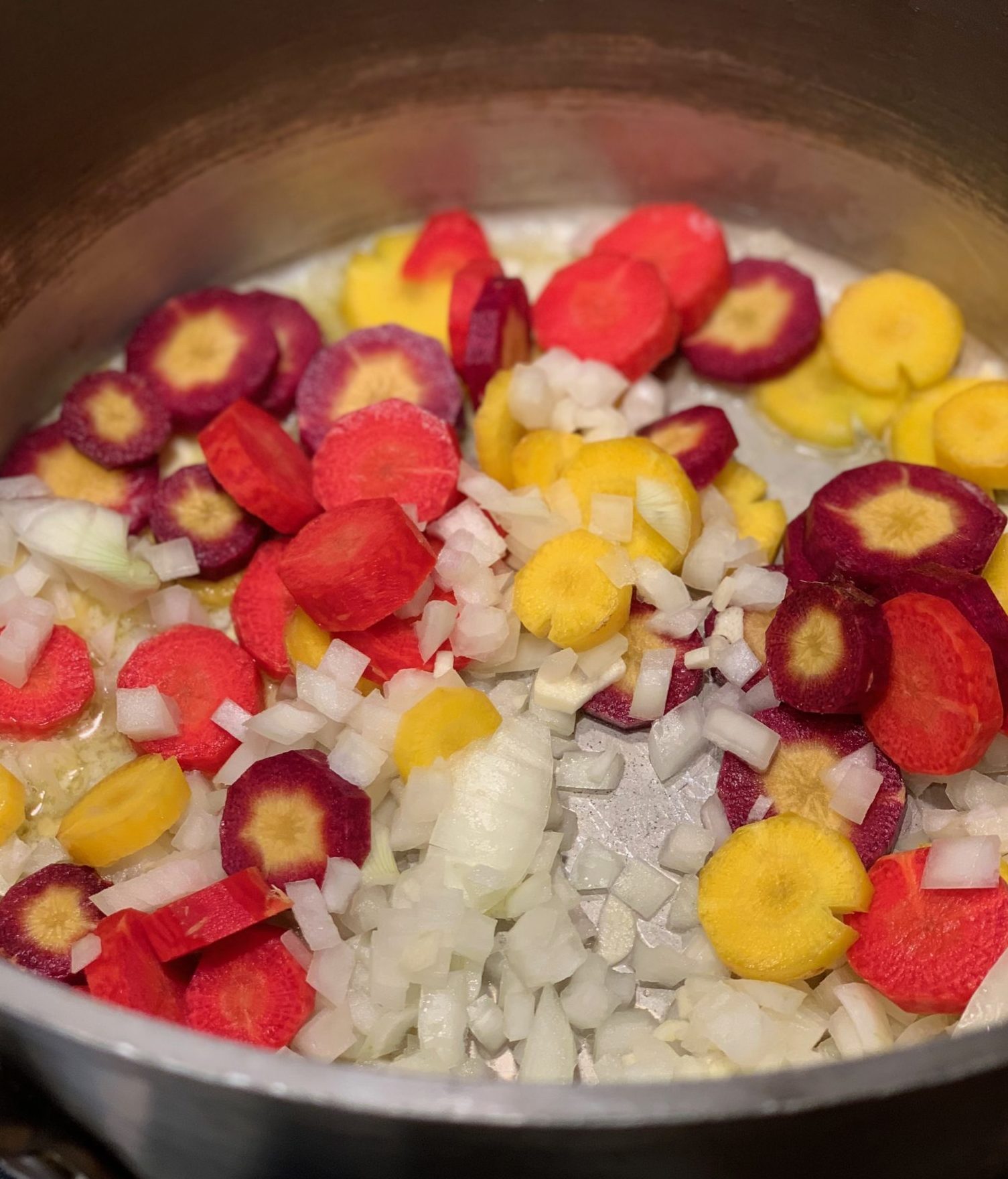 onions and carrots "sweating" in a pot