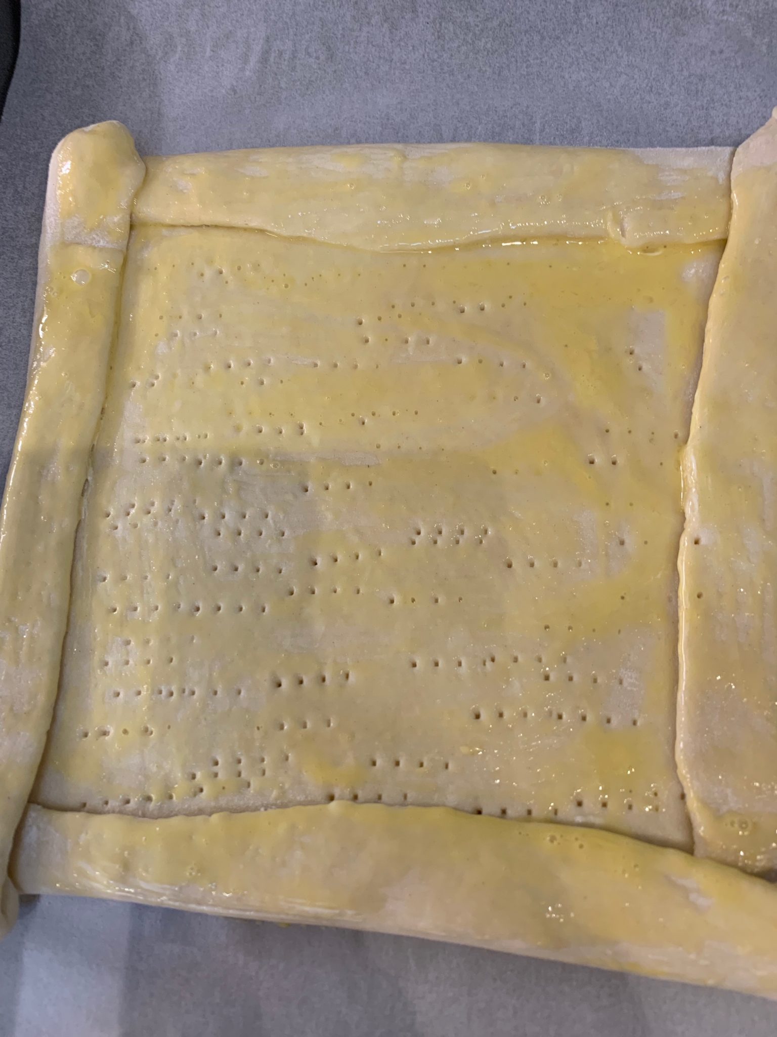 Puff pastry tart brushed with egg wash