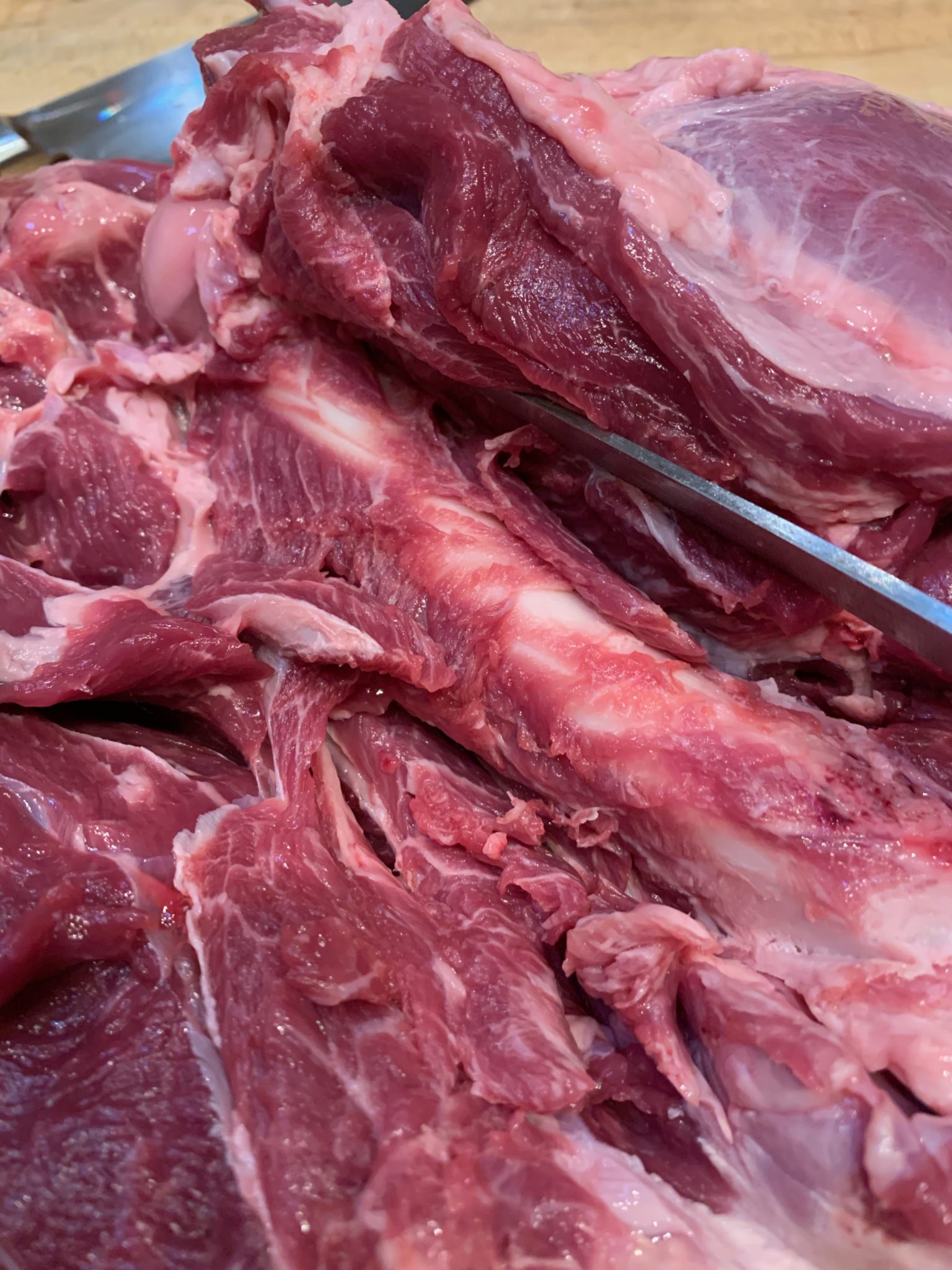 removing the bone from a whole leg of lamb