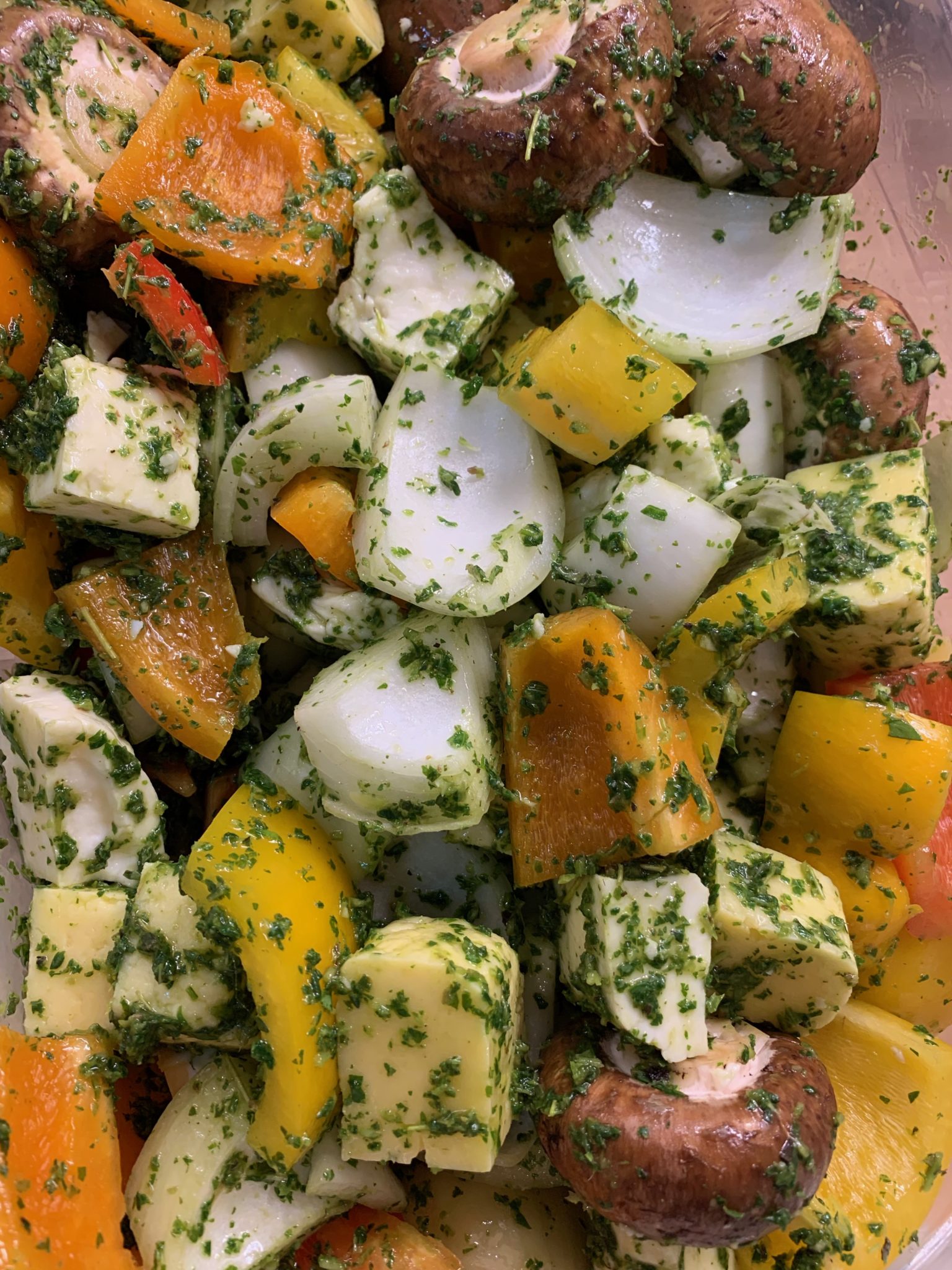 Herb marinade on vegetables and cheese