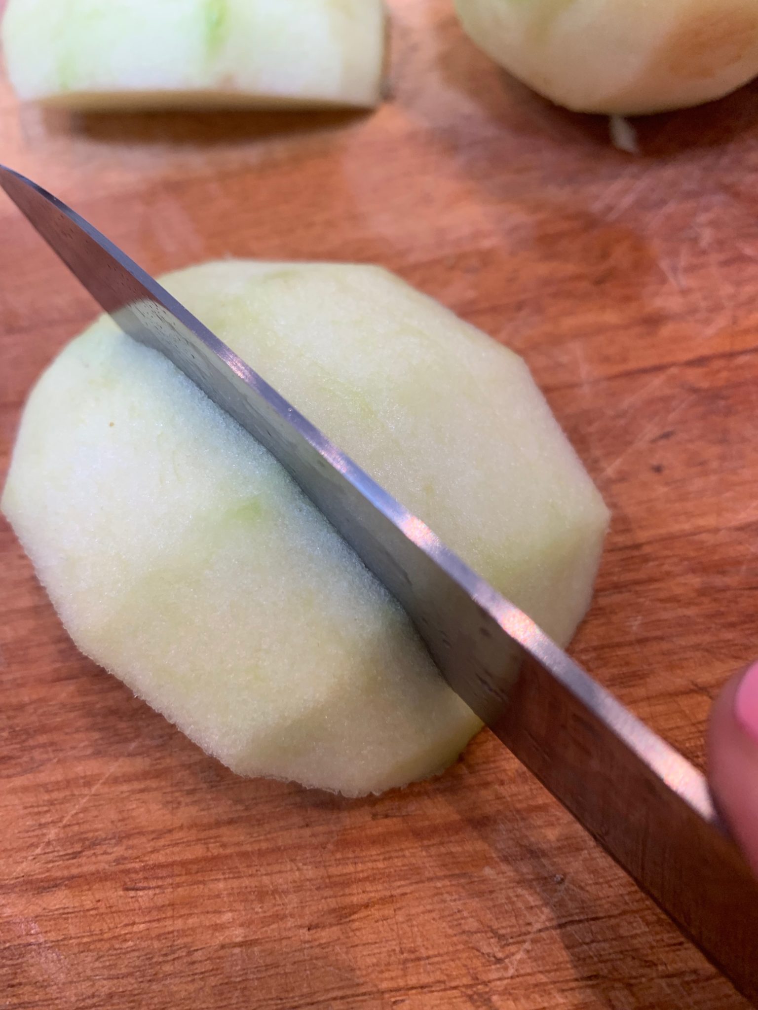 Cutting an apple quarter partway through