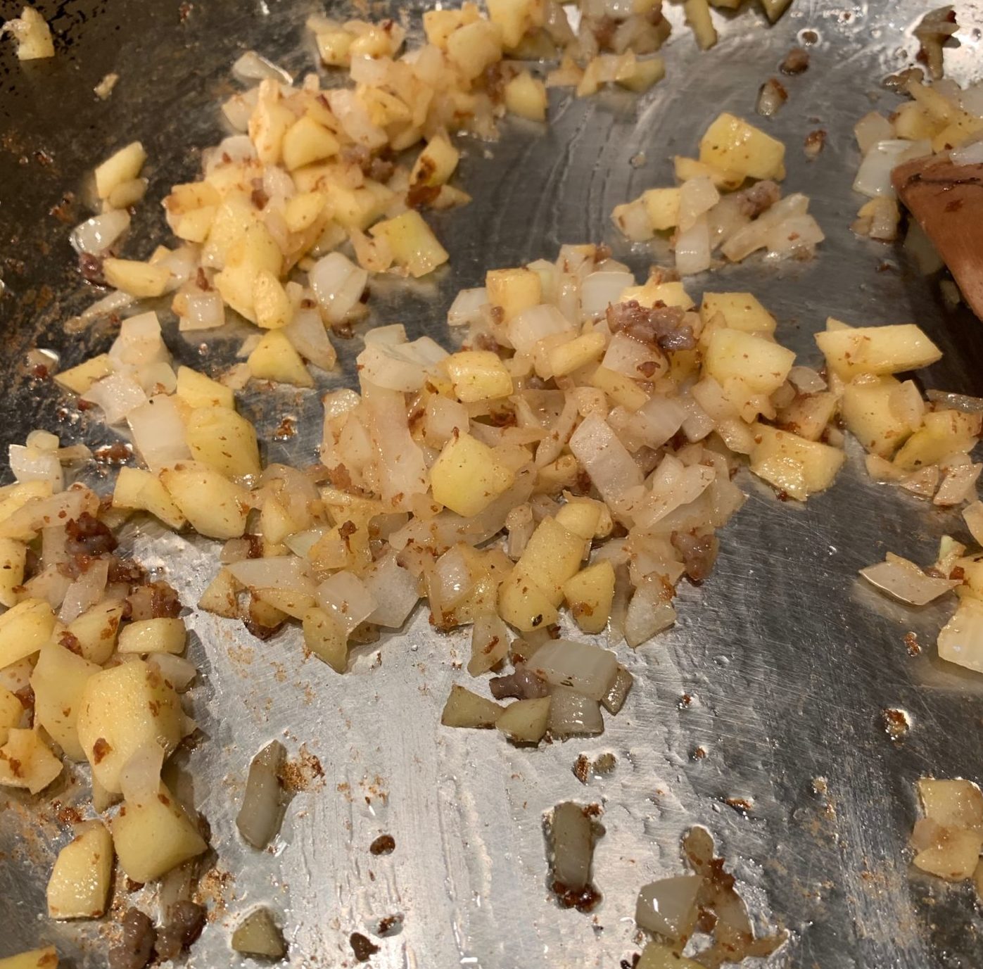 Onions cooked until translucent with apple bits