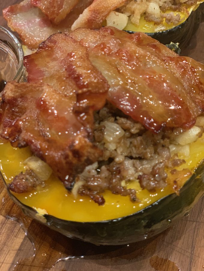 To show finished Apple and Sausage Stuffed Acorn Squash with Bacon dish