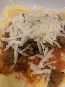 Pasta with fresh sauce, sausage and grated cheese