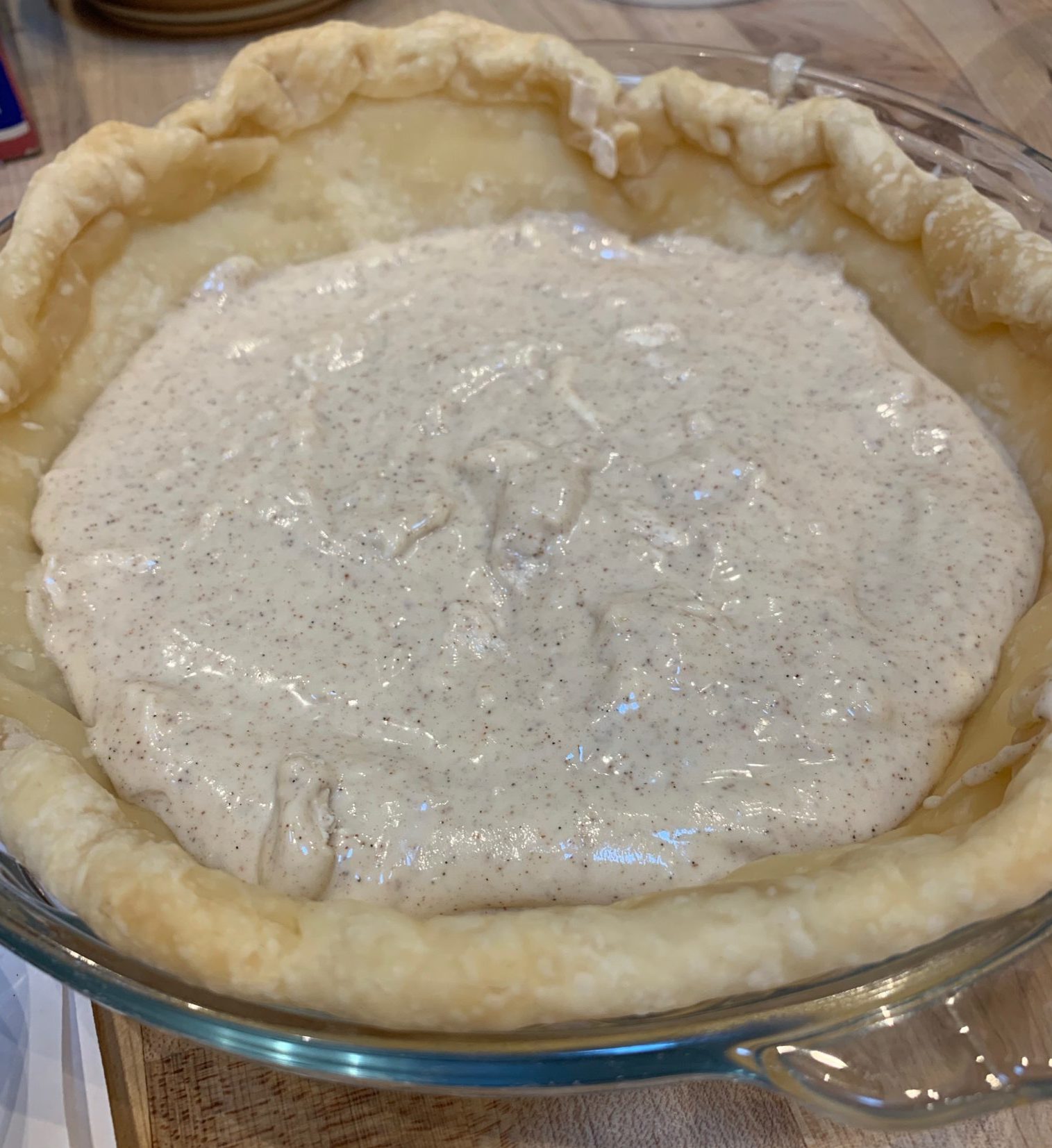 Showing the unbaked cheesecake layer in a pie crust