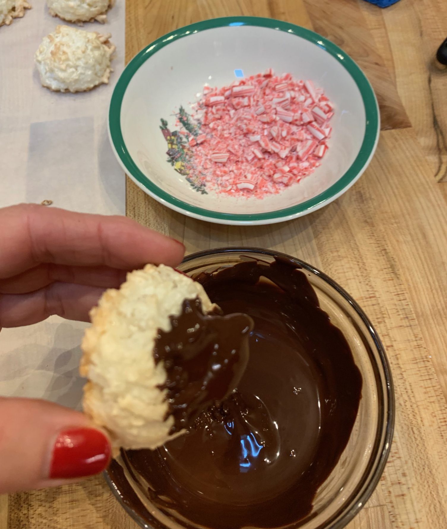 Dipping a macaroon in chocolate