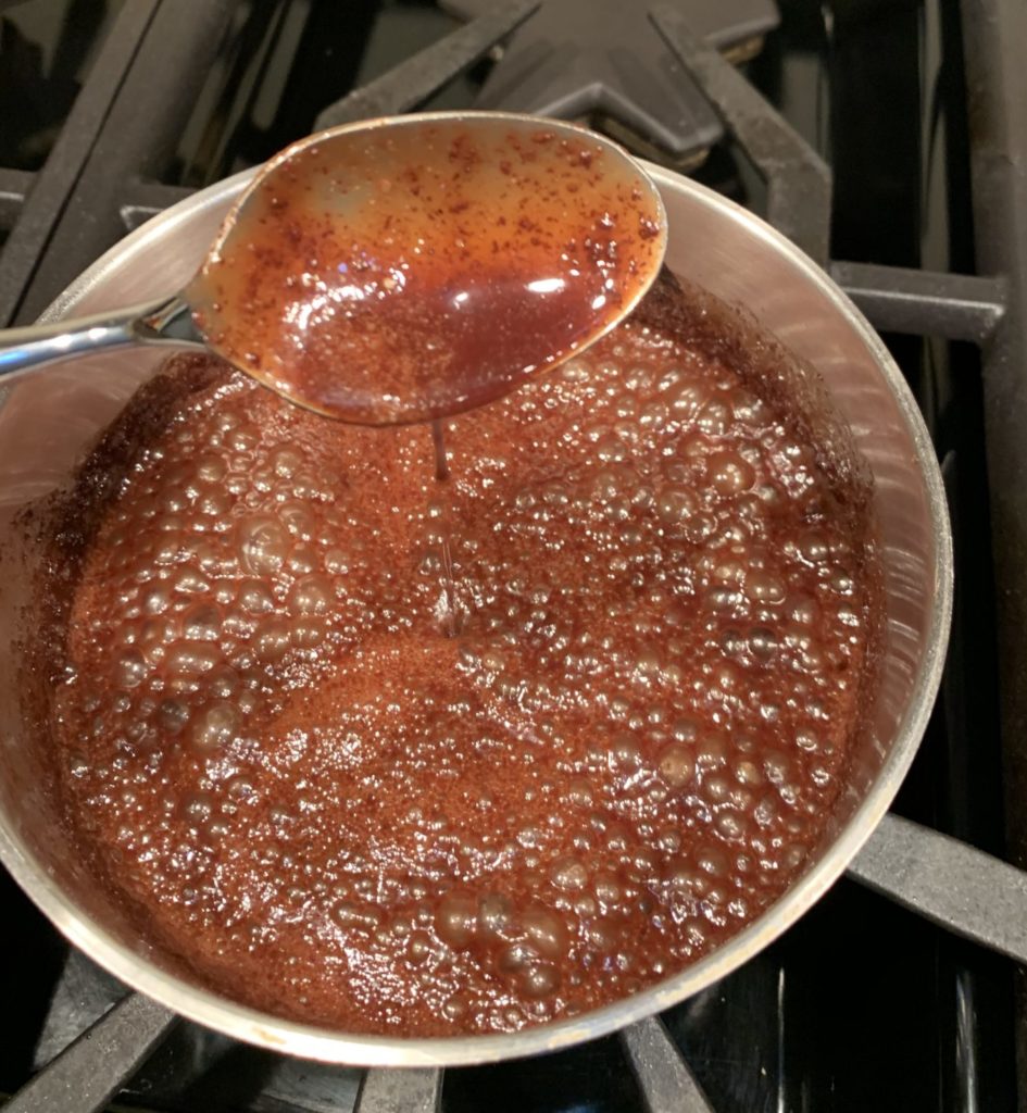 Chocolate sauce coating a spoon