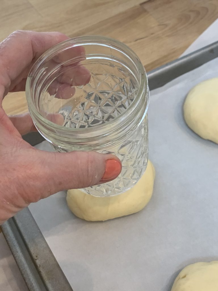 use a mason jar to press a well in the dough