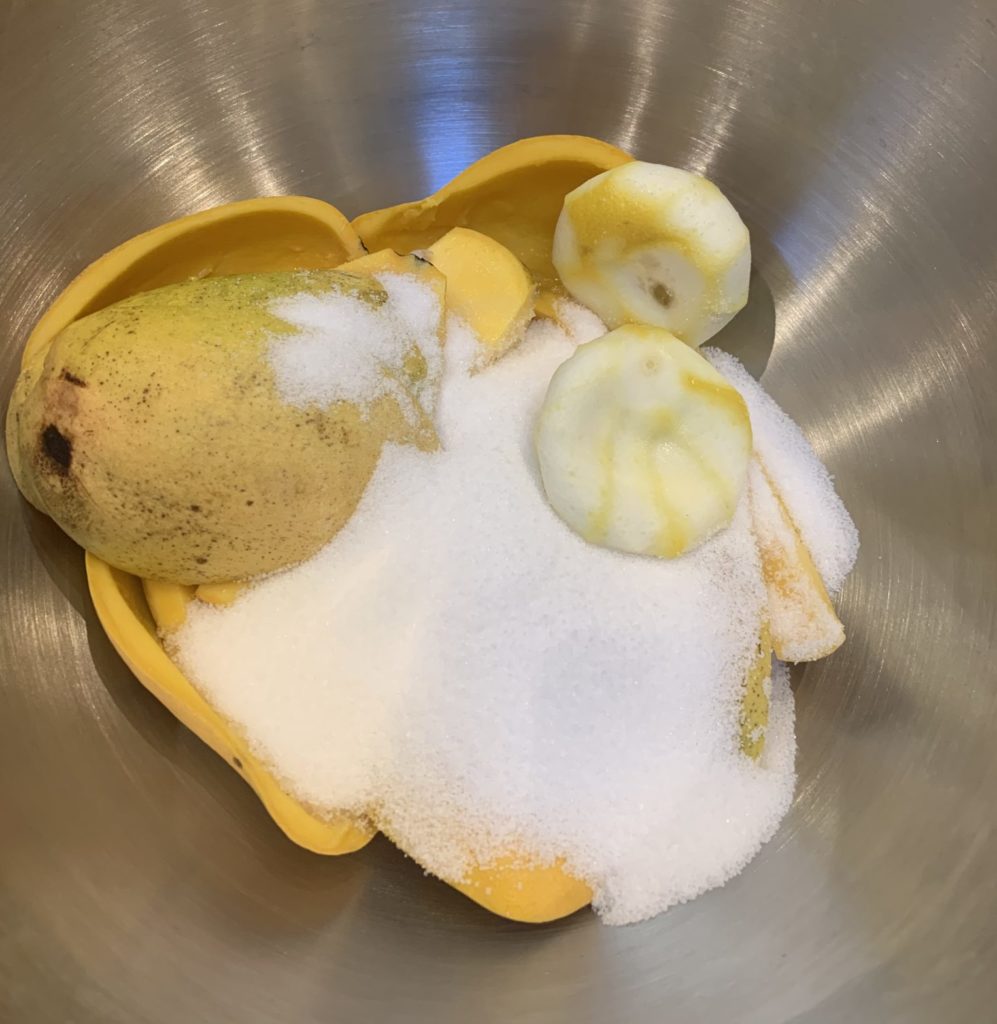 Mango and lemon peels in a bowl with sugar