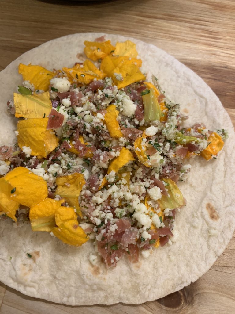 Tortilla topped with squash blossom mixture