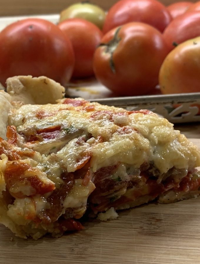 Showing the layered tomatoes in a slice of Pimento Cheese Tomato Pie