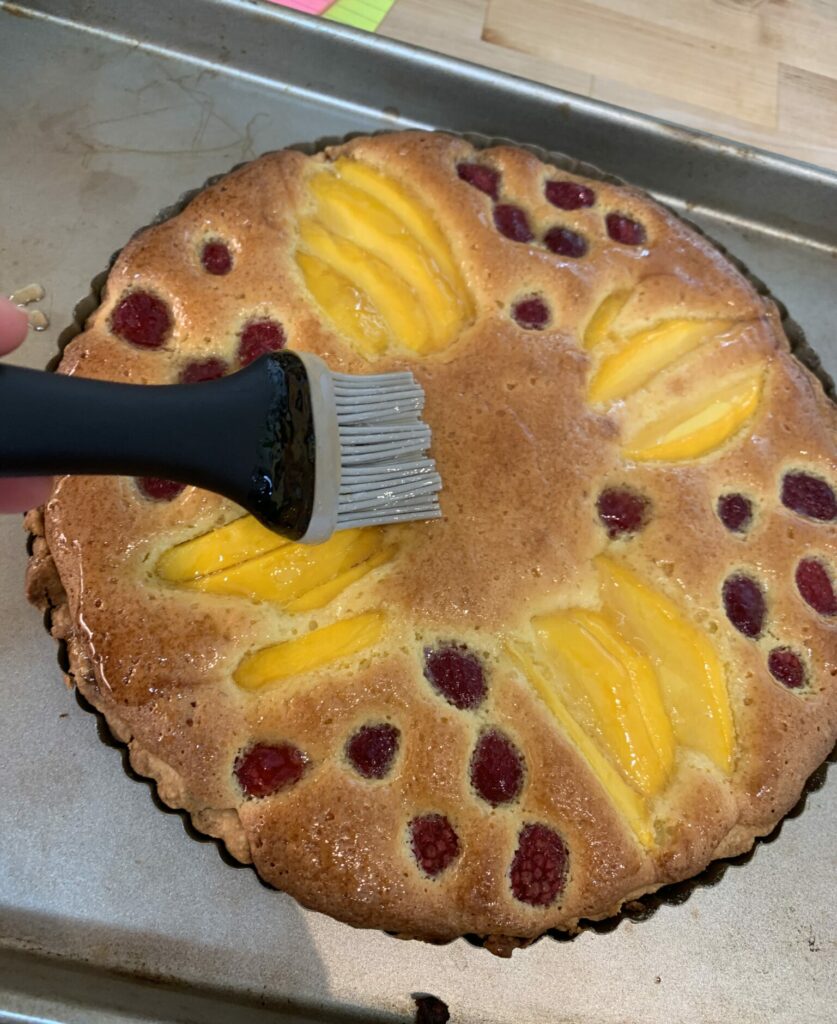 Brushing a fruit tart with glaze