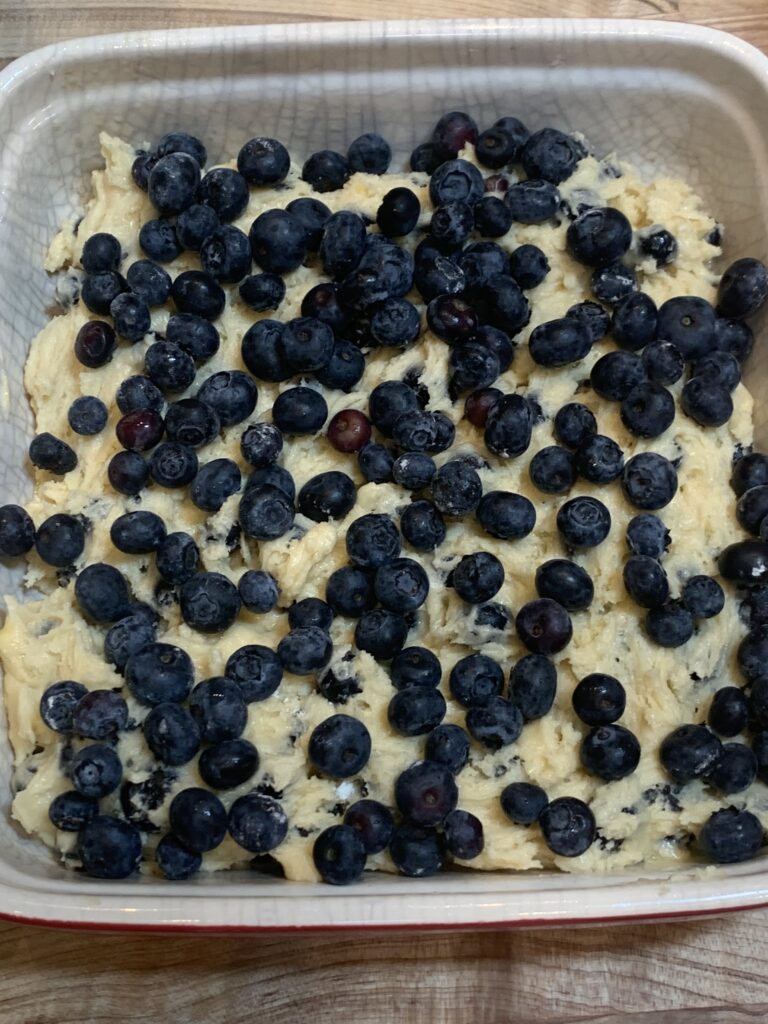 Cover the cake batter with Blueberries