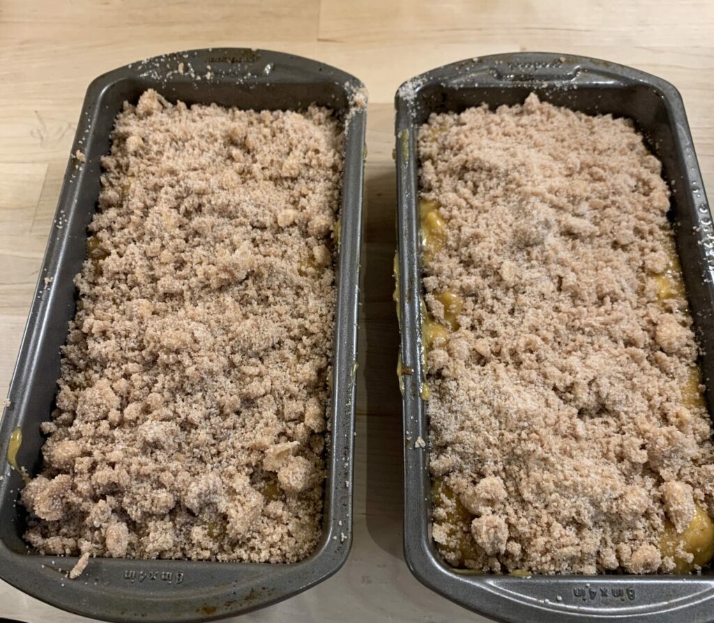 Two loaf pans of apple, pumkin, spice bread