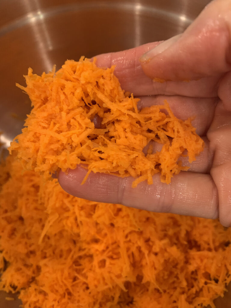 Break up clumps of grated carrot with your fingers