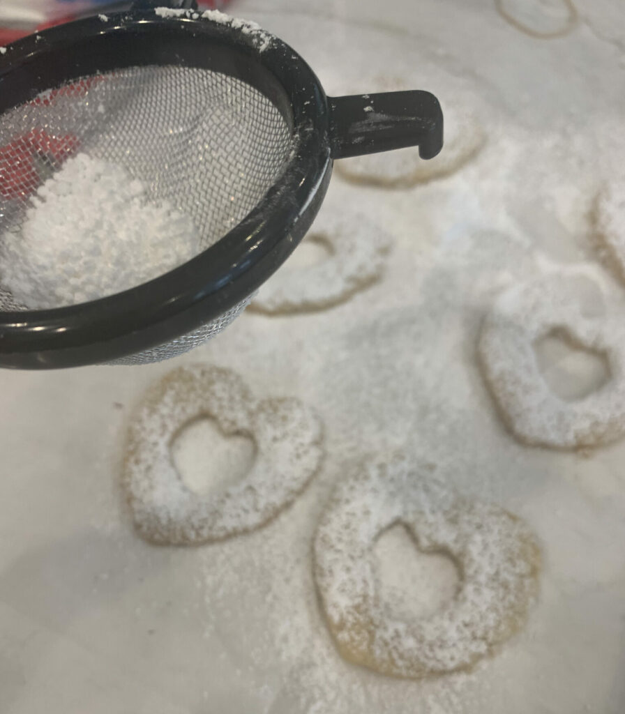 Dusting the tops of cookies with sugar