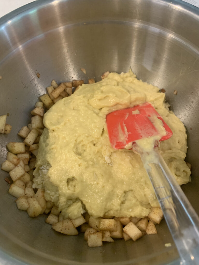 Stirring apples in to cake batter